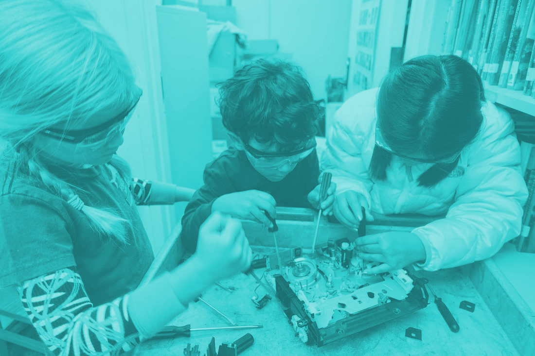 This is an image of students taking apart a hard drive.