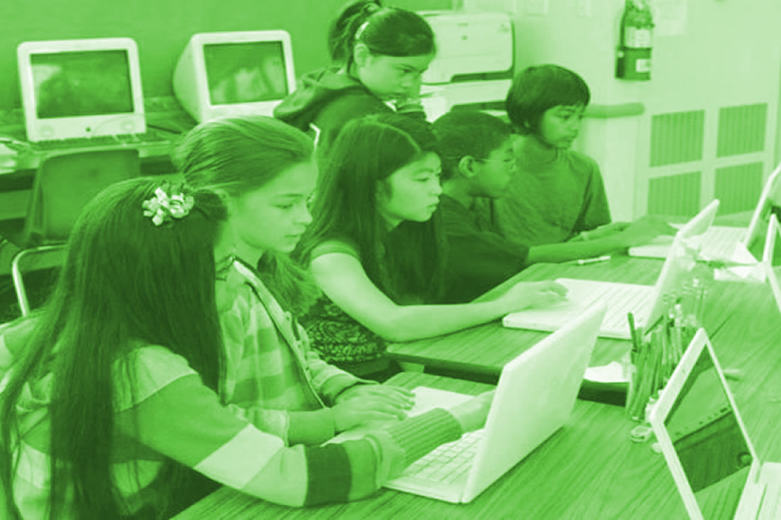 This is an image of students working at a computer