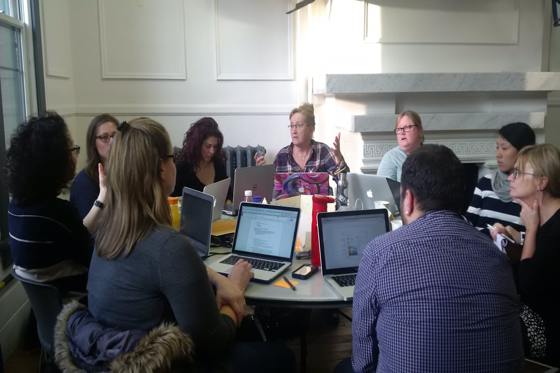 This is an image of a teachers working on laptops together
