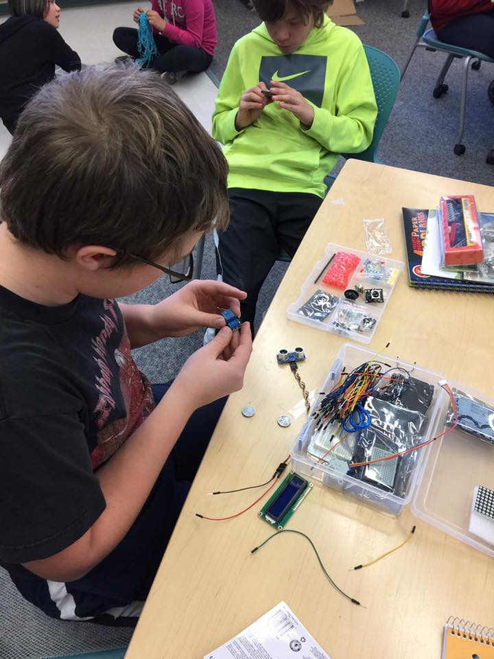 picture of kids at table working on robotics
